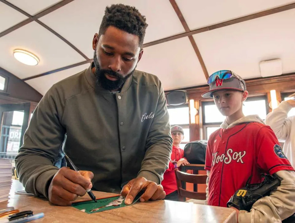 Former Boston Red Sox player Jackie Bradley Jr. signs an autograph for Junior WooSox player Colton Amato of Shrewsbury on opening day at Polar Park Friday.Rick Cinclair&sol;Telegram & Gazette &sol; USA TODAY NETWORK via Imagn Images