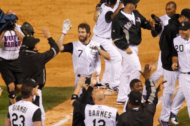 Colorado Rockies' Seth Smith, center, is ...