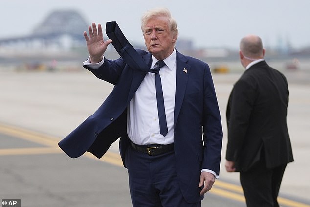 President Donald Trump waves as he arrives at Newark Liberty International Airport