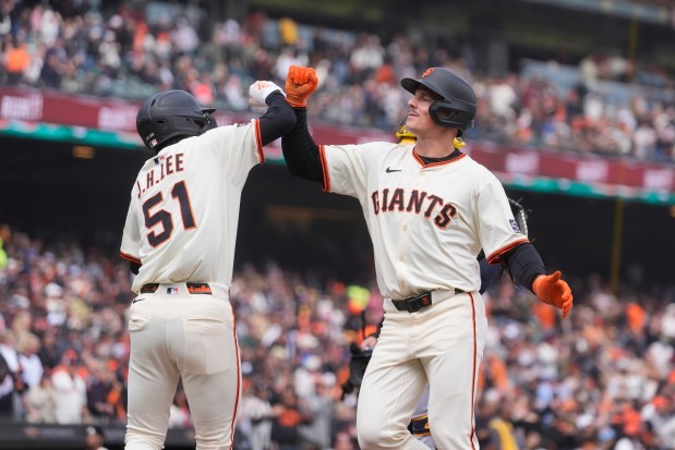 San Francisco Giants' Matt Chapman, right, celebrates after hitting a two-run home run that also scored Jung Hoo Lee (51) during the fifth inning of a baseball game against the Milwaukee Brewers in San Francisco, Thursday, April 24, 2025. (AP Photo/Jeff Chiu)