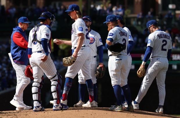 Cubs starting pitcher Ben Brown hands over the ball to manager Craig Counsell as Brown is pulled from the game in the fourth inning against the Phillies at Wrigley Field on April 26, 2025. (Chris Sweda/Chicago Tribune)