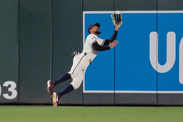 Minnesota Twins center fielder Byron Buxton (25) catches a fly out by Chicago White Sox's Andrew Benintendi (23) as the final out of a baseball game Tuesday, April 22, 2025, in Minneapolis. (AP Photo/Abbie Parr)