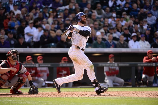 Colorado Rockies' Charlie Blackmon (19) hits a home run in the fourth inning, batting in DJ LeMahieu, during the Rockies' season home opener against the Arizona Diamondbacks at Coors Field in Denver, on Friday, April 4, 2014. (Photo by Hyoung Chang/The Denver Post)