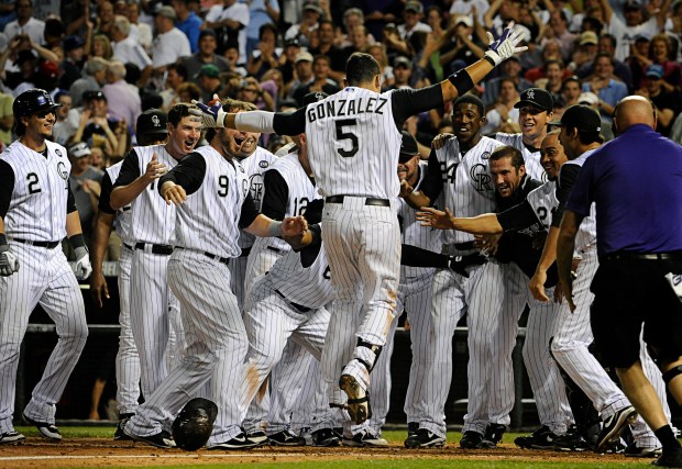 Colorado Rockies left-fielder Carlos Gonzalez (5) jumps to home plate after rounding the bases on his walk-off solo home run in the bottom of the ninth inning to beat the Chicago Cubs 6-5 at Coors Field, July 31, 2010, in Denver. (Photo by Diego James Robles/The Denver Post)