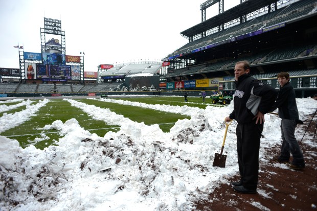 Rockies owner Dick Monfort takes a break from shoveling snow on the right field line before a double header against the New York Mets on April 16, 2013, at Coors Field in Denver. (Photo By John Leyba/The Denver Post)