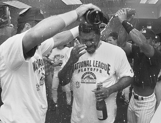 Colorado Rockies manager Don Baylor, center, is doused with champagne by first baseman Andres Galarraga, left, and Trenidad Hubbard, right, in the Rockies clubhouse after the Rockies clinched the National League wildcard playoff spot in Denver on Sunday, Oct. 1, 1995. (AP Photo/Ed Andrieski)