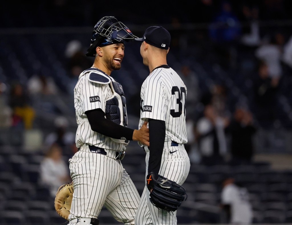 J.C. Escarra and Luke Weaver of the New York Yankees celebrating their 5-1 win over the Toronto Blue Jays at the Yankee Stadium