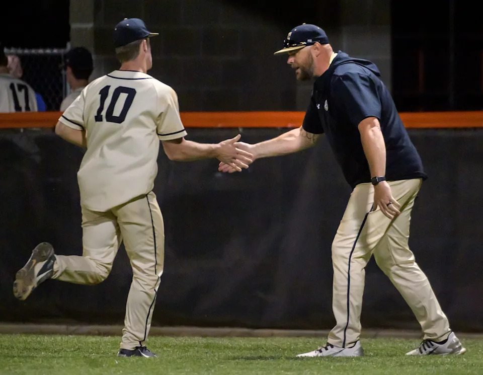 Galesburg head coach Jeremy Pickrel slaps hands with relief pitcher Grant Aten after the sixth inning against Washington during their Class 3A baseball sectional semifinal Wednesday, June 1, 2022 at Brian Wisher Field in Washington. The Panthers advanced to the sectional title game with a 3-2 victory. They'll face Morton for the sectional title at 11 a.m. Saturday in Washington.
