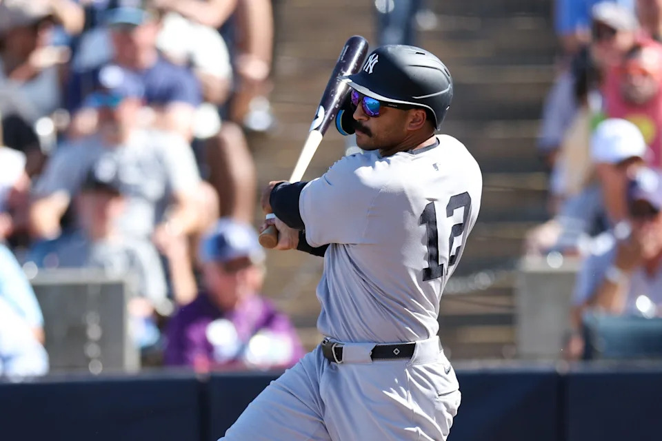 Apr 19, 2025; Tampa, Florida, USA; New York Yankees center fielder Trent Grisham (12) hits a home run against the Tampa Bay Rays in the second inning at George M. Steinbrenner Field. Mandatory Credit: Nathan Ray Seebeck-Imagn Images
