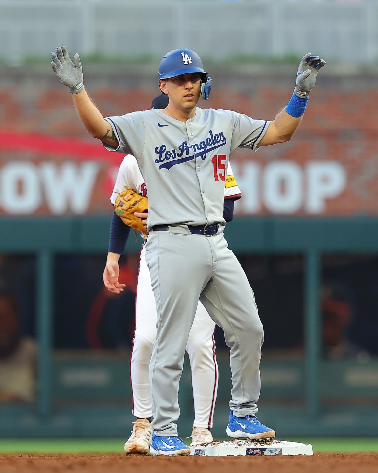 Austin Barnes #15 of the Los Angeles Dodgers reacts after hitting a double.
