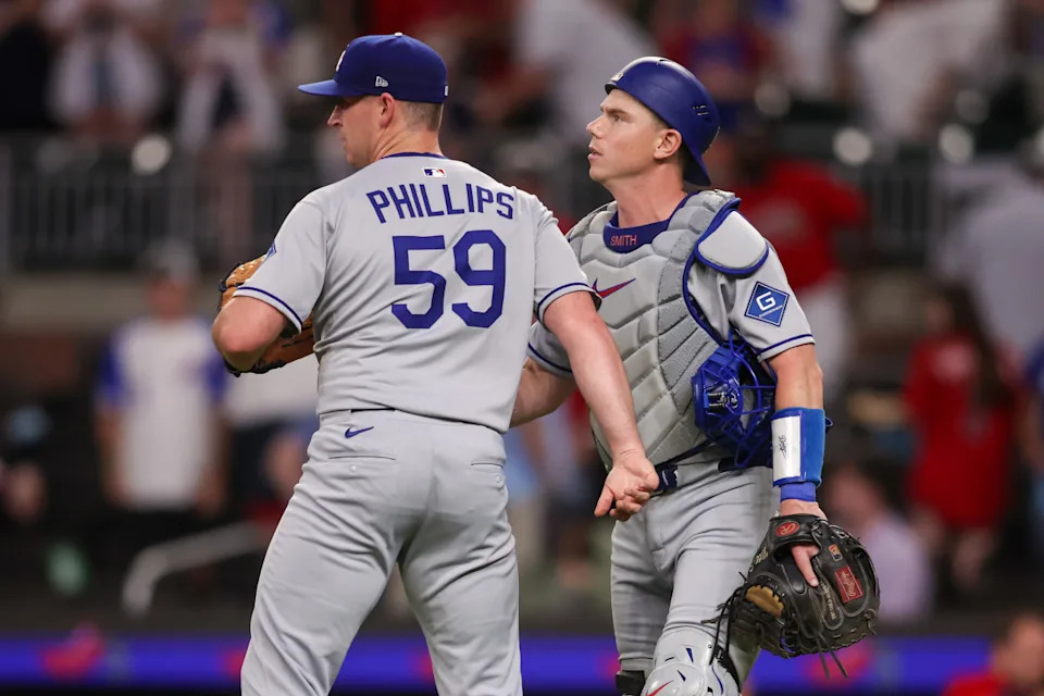 May 2, 2025; Atlanta, Georgia, USA; Los Angeles Dodgers relief pitcher Evan Phillips (59) and catcher Will Smith (16) celebrate after a victory over the Atlanta Braves at Truist Park. Mandatory Credit: Brett Davis-Imagn