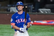 Texas Rangers outfielder Evan Carter reacts as he strikes out to end the eighth inning of an...