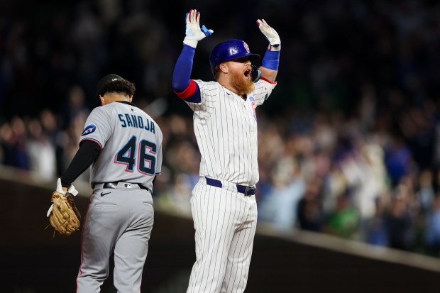 Chicago Cubs pinch hitter Justin Turner (3) celebrates after hitting a walk-off two RBI double to give the Cubs a 5-4 win over the Miami Marlins at Wrigley Field Tuesday May 13, 2025, in Chicago. (Armando L. Sanchez/Chicago Tribune)
