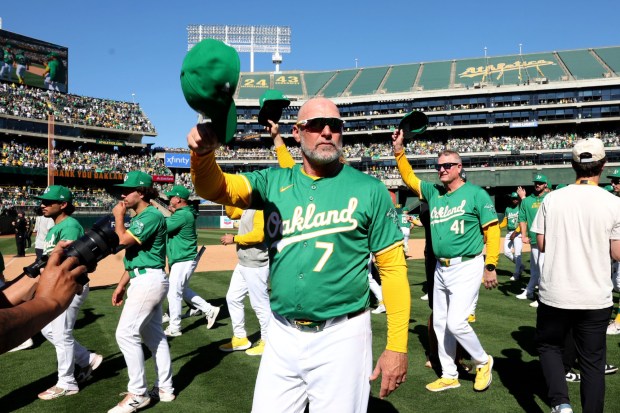 Oakland Athletics manager Mark Kotsay, center, and his team aknowledges fans after the A's played the last home game at the Coliseum in Oakland, Calif., on Thursday, Sept. 26, 2024. The Oakland Athletics won 3-2 against the Texas Rangers. The A's will move to Sacramento next season. (Ray Chavez/Bay Area News Group)