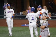 Texas Rangers designated hitter Joc Pederson (4) celebrates with his teammates Marcus...