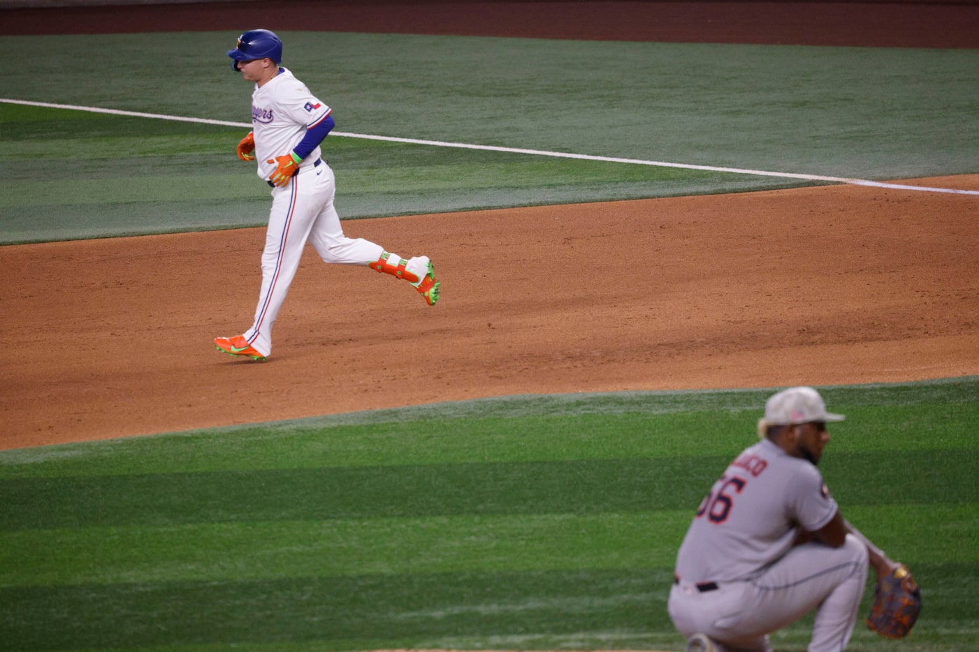 Texas Rangers designated hitter Joc Pederson (4) runs the bases after hitting a home run as...