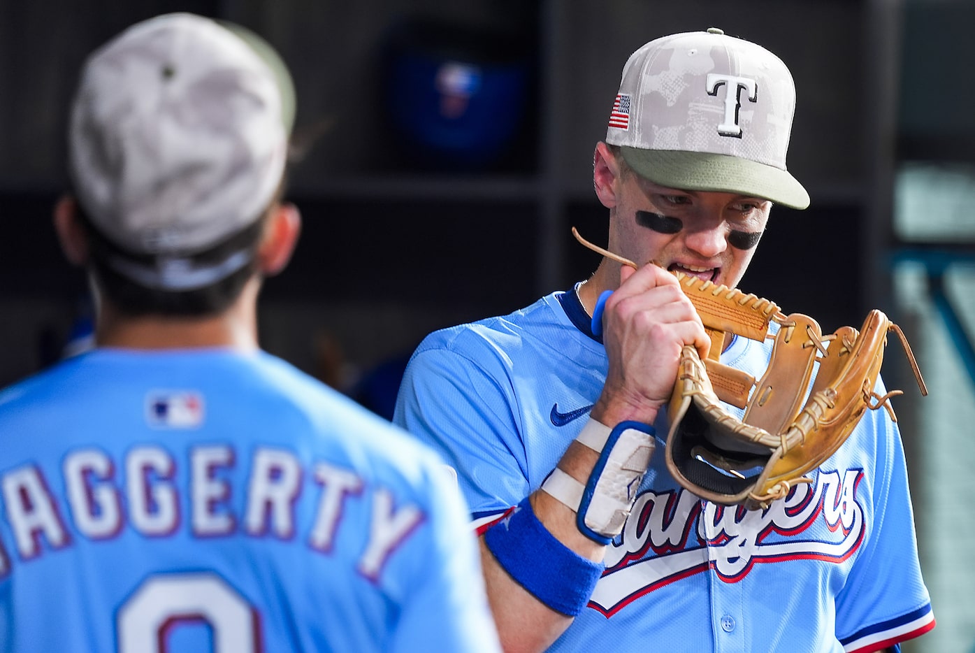Texas Rangers third baseman Josh Jung bites his glove in the dugout after a 4-3 loss to the...