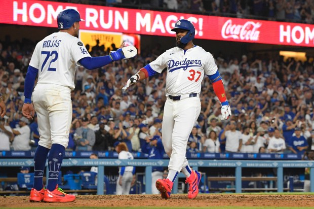 The Dodgers’ Teoscar Hernández, right is congratulated by teammate Miguel...