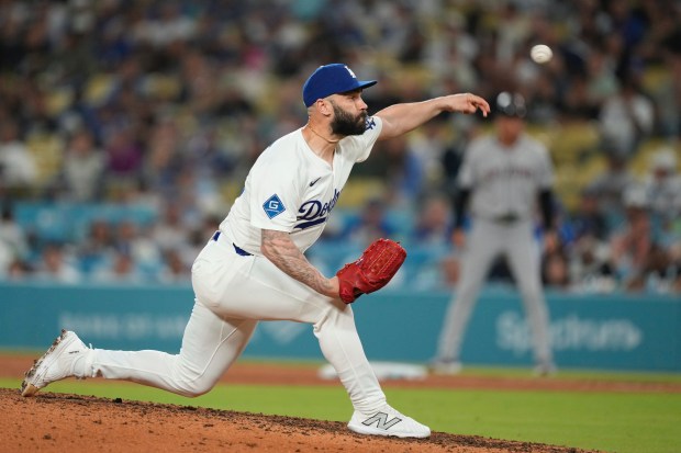 Dodgers relief pitcher Tanner Scott throws to the plate during...