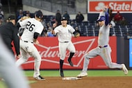 New York Yankees shortstop Anthony Volpe, center, reacts after second baseman DJ LeMahieu,...