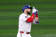 Texas Rangers first base Jake Burger (21)  gestures after hitting a double during the fourth...