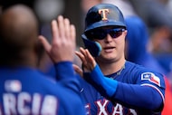 Texas Rangers designated hitter Joc Pederson (4) celebrates after scoring on a sacrifice fly...