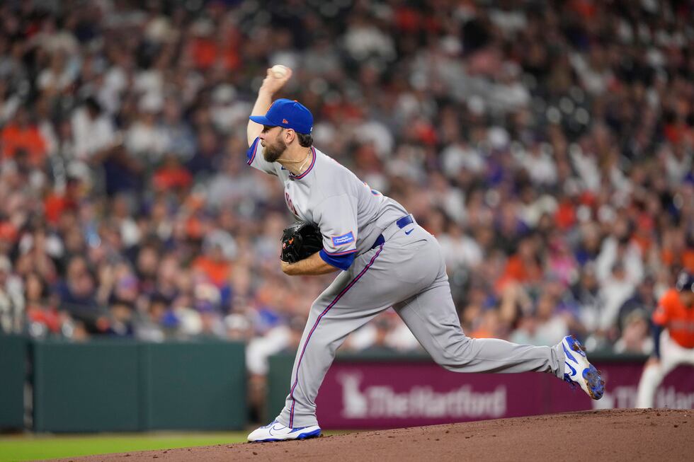 New York Mets starting pitcher Tylor Megill throes during the first inning of a baseball game...