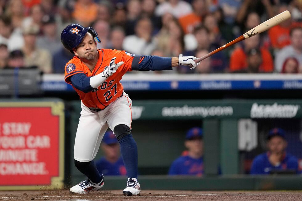 Houston Astros' Jose Altuve strikes out during the first inning of a baseball game against the...