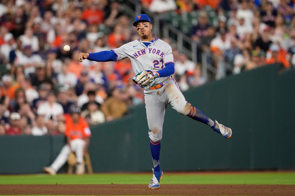 New York Mets third baseman Mark Vientos throws to first for the out after fielding a ground...
