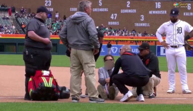 Injured Detroit Tigers groundskeeper flips off camera while being attended to by medical staff
