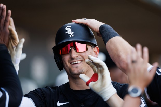 White Sox shortstop Colson Montgomery celebrates in the dugout after homering against the Cubs in a spring training game Feb. 22, 2025, in Mesa, Ariz. (Armando L. Sanchez/Chicago Tribune)