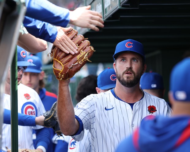 Chicago Cubs relief pitcher Drew Pomeranz is congratulated by his teammates in the dugout after finishing off the Colorado Rockies in the eighth inning of a game at Wrigley Field in Chicago on May 26, 2025. (Chris Sweda/Chicago Tribune)