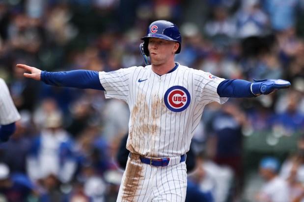 Chicago Cubs outfielder Pete Crow-Armstrong (4) celebrates scoring a run after outfielder Seiya Suzuki (27) hit a sacrifice fly in the first inning against the Chicago White Sox at Wrigley Field on Sunday, May 18, 2025. (Eileen T. Meslar/Chicago Tribune)