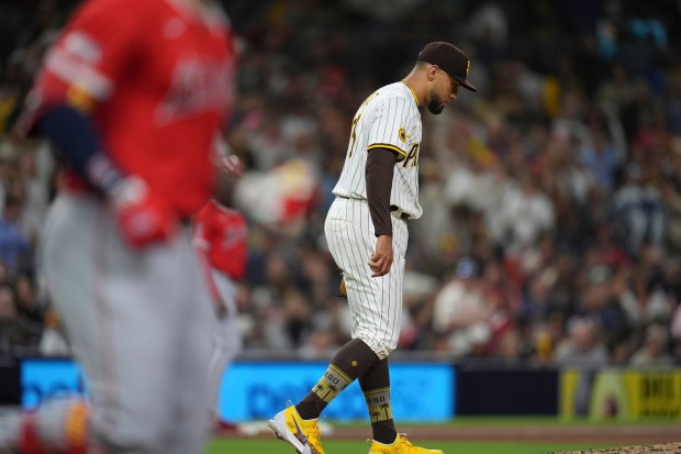 San Diego Padres relief pitcher Robert Suarez walks back to the mound after walking the Angels' Yoan Moncada with the bases loaded to score a run during the ninth inning of a baseball game Monday, May 12, 2025, in San Diego. (AP Photo/Gregory Bull)