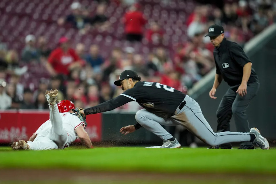 Cincinnati Reds first baseman Spencer Steer is tagged out by Chicago White Sox third baseman Miguel Vargas at third base.
