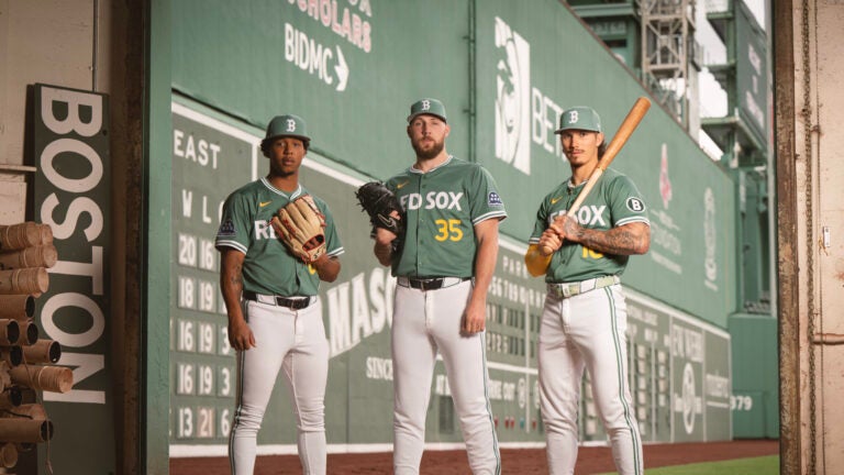 Brayan Bello #66 of the Boston Red Sox, Garrett Crochet #35 of the Boston Red Sox, and Jarren Duran #16 of the Boston Red Sox pose for portraits outside the Green Monster wearing the new City Connect jerseys in Boston, Massachusetts.