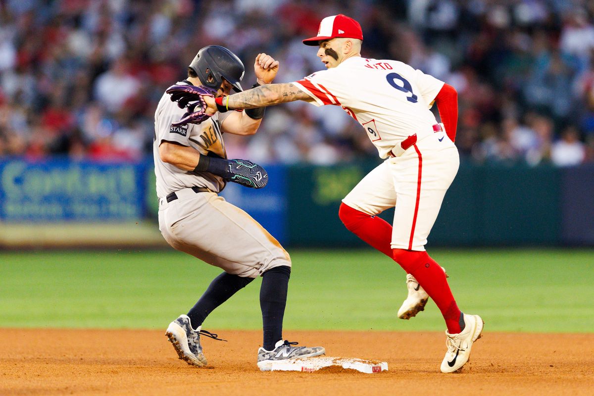 Zach Neto #9 of the Los Angeles Angels catches the ball as Austin Wells #28 of the New York Yankees tags second base during the game at Angel Stadium of Anaheim on May 27, 2025 in Anaheim, California. 