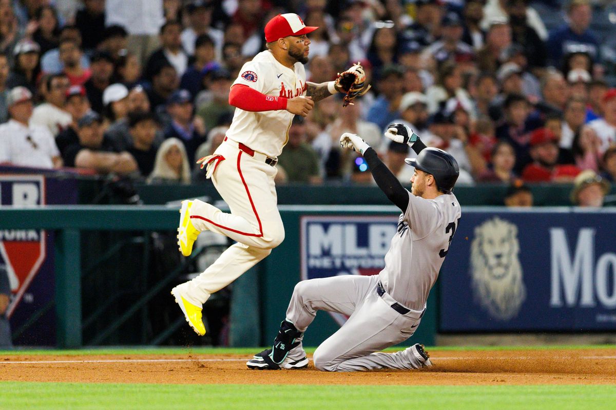 Cody Bellinger #35 of the New York Yankees slides into third base against Yoán Moncada #5 of the Los Angeles Angels during the game at Angel Stadium of Anaheim on May 27, 2025 in Anaheim, California. 