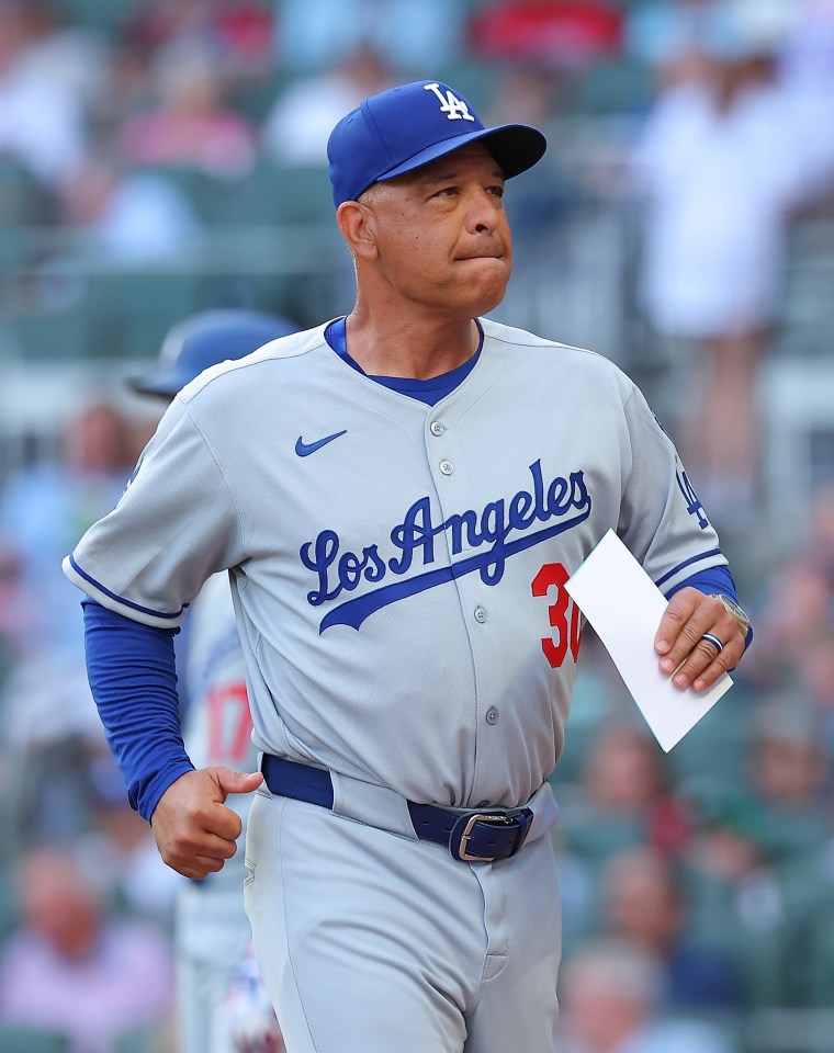 Dave Roberts, manager of the Los Angeles Dodgers, walks off the field.