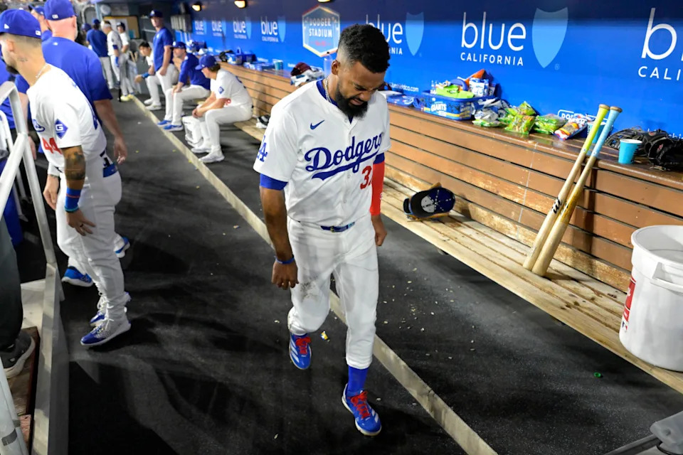 Sep 6, 2024; Los Angeles, California, USA; Los Angeles Dodgers left fielder Teoscar Hernandez (37) grimaces as he walks through the dugout when he left the game after being hit by a pitch in the first inning against the Cleveland Guardians at Dodger Stadium.Mandatory Credit&colon; Jayne Kamin-Oncea-Imagn Images