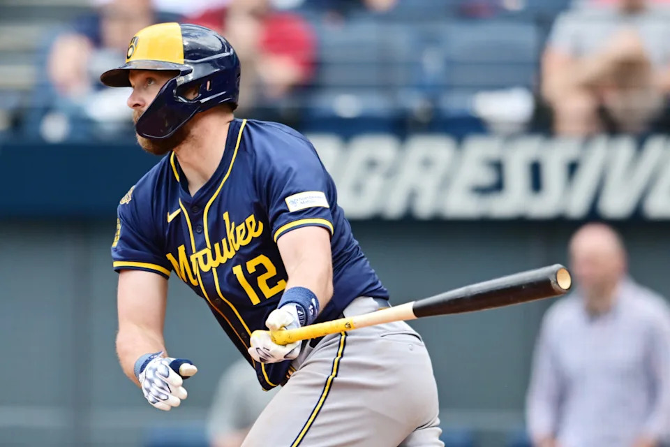 Milwaukee Brewers first baseman Rhys Hoskins (12) hits an RBI single during the ninth inning against the Cleveland Guardians at Progressive Field.Ken Blaze-Imagn Images