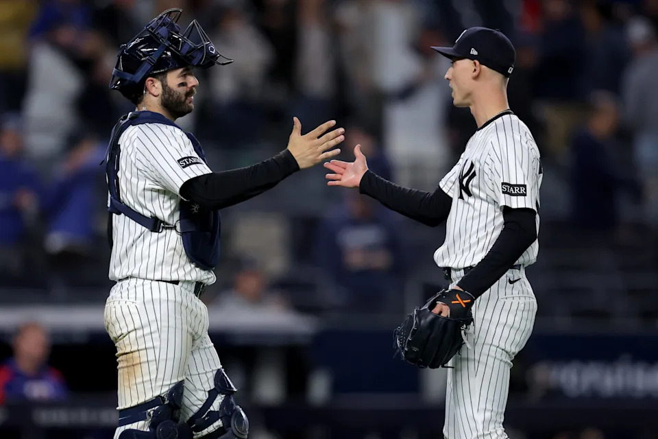 May 20, 2025; Bronx, New York, USA; New York Yankees catcher Austin Wells (28) and relief pitcher Luke Weaver (30) celebrate after defeating the Texas Rangers at Yankee Stadium.