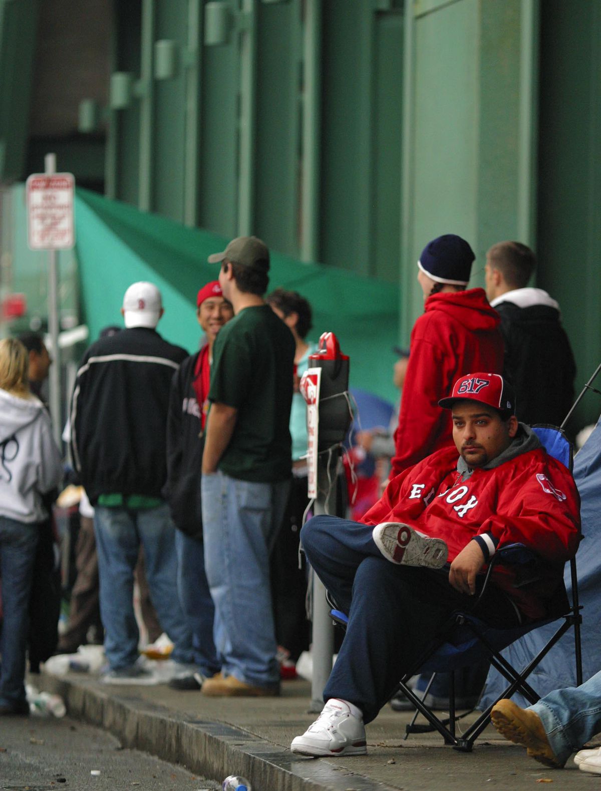 Joey Marks of Cambridge, Mass. waits in line outside of Fenway Park in Boston on Friday. Marks, who