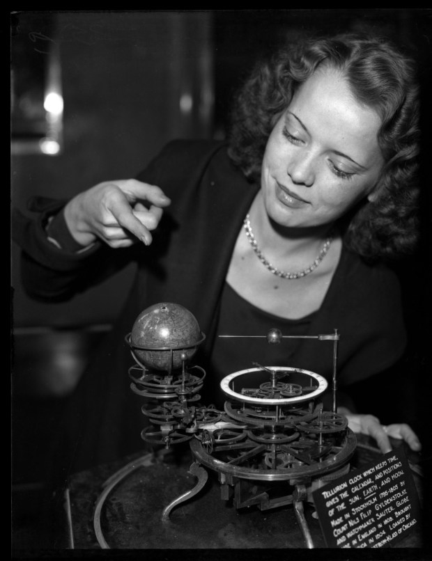 Nell Rettke points to the Tellurion clock, an old-time astronomical...