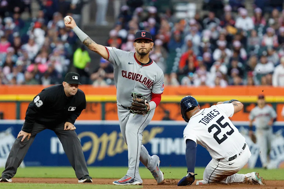 Cleveland Guardians second baseman Gabriel Arias (13) throws to first after tagging out Detroit Tigers baserunner Gleyber Torres (25) out at second base May 24, 2025, in Detroit, Michigan.
