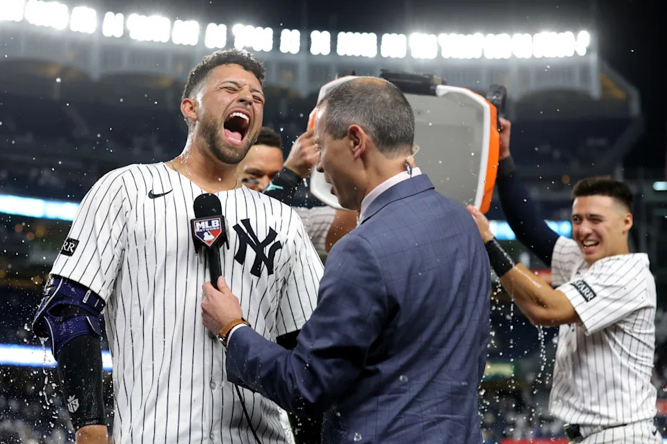 Yankees pinch hitter J.C. Escarra (25) reacts to being doused after a win against the Padres.Brad Penner-Imagn Images