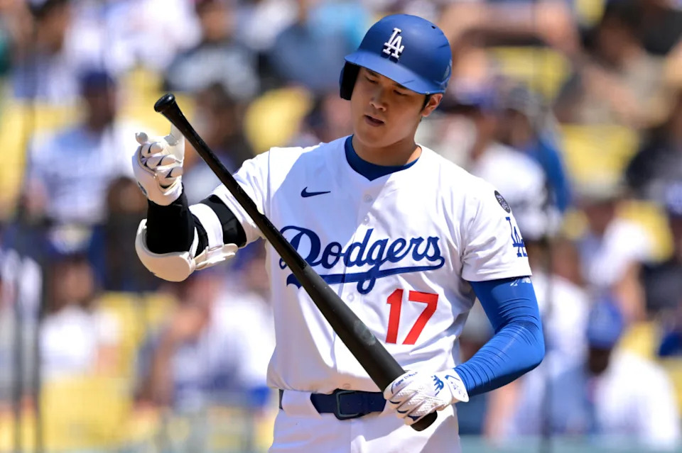 Los Angeles Dodgers designated hitter Shohei Ohtani (17) checks his bat in the fifth inning against the Los Angeles Angels at Dodger Stadium.Jayne Kamin-Oncea-Imagn Images