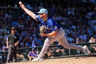Texas Rangers pitcher Adrian Houser pitches during the third inning of a spring training...