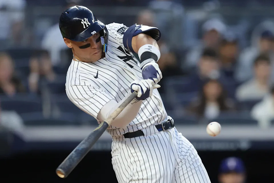 May 20, 2025; Bronx, New York, USA; New York Yankees right fielder Aaron Judge (99) hits a single against the Texas Rangers during the fourth inning at Yankee Stadium.