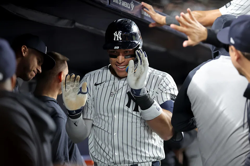 May 20, 2025; Bronx, New York, USA; New York Yankees right fielder Aaron Judge (99) celebrates his two run home run against the Texas Rangers with teammates in the dugout during the eighth inning at Yankee Stadium.